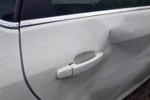 dented white car