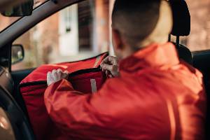 food delivery driver in car