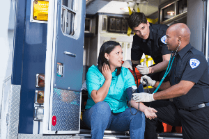 EMT evaluating a woman after an accident 