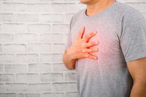 Man clutching his chest in pain