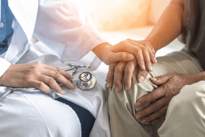Doctor holding a patient's hand