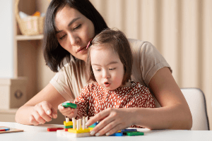 Mother helping daughter with Down Syndrome. 