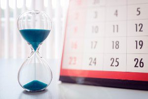 calendar with hourglass with blue sand
