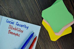 social security disability benefits with pens and paper