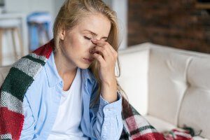 woman rubbing nose because she's tired