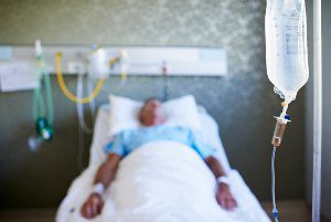 older man lying on hospital bed