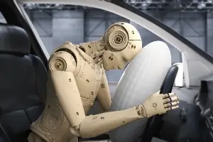 crash dummy in front seat of car after striking head on deployed airbag
