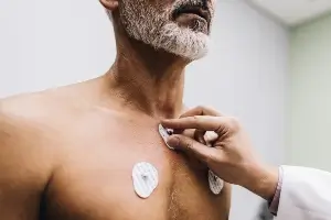 medical professional doing an EKG on male patient
