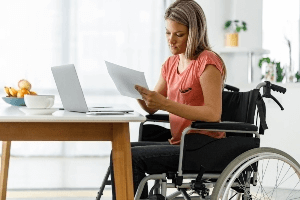 young woman in wheelchair reviewing paperwork
